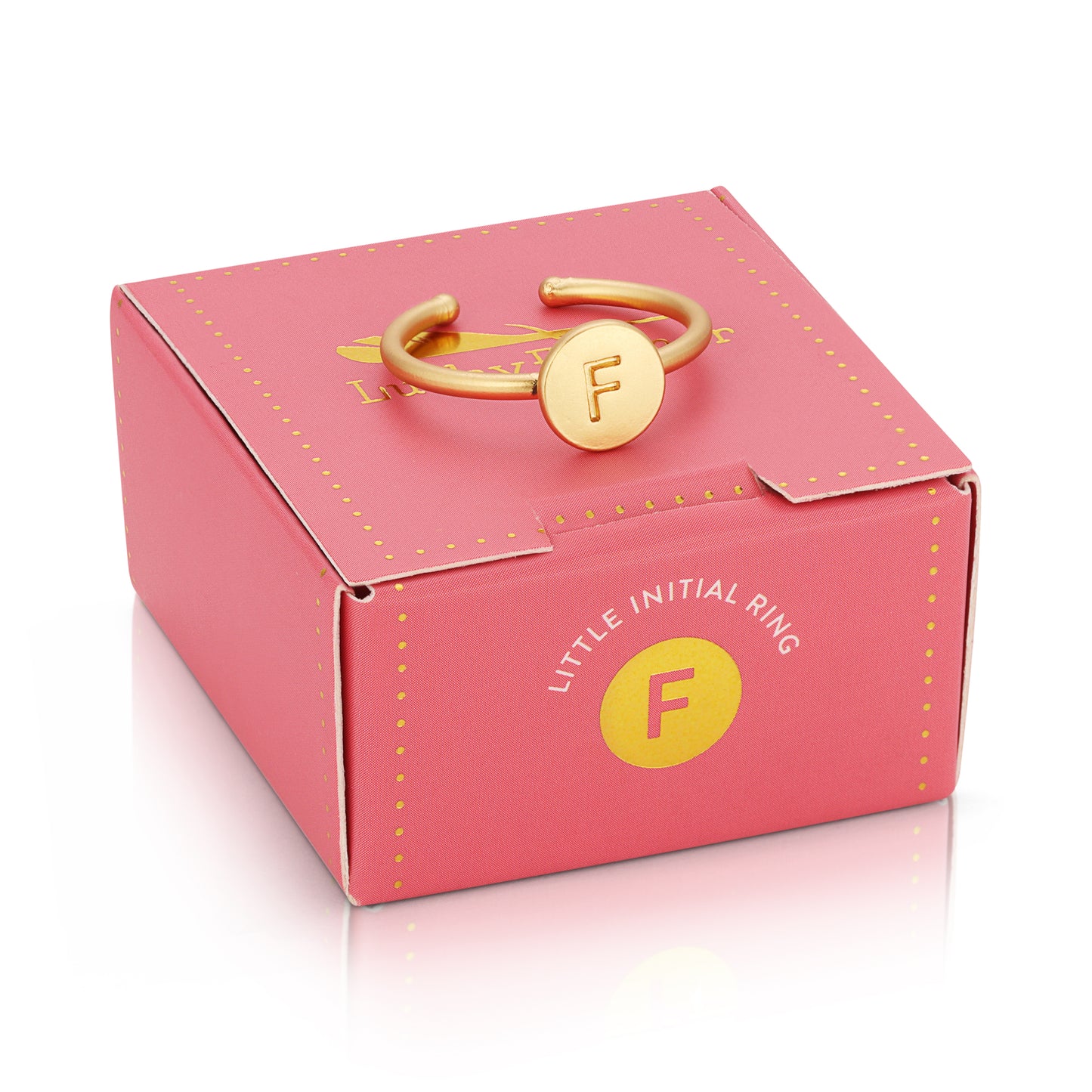 A gold-colored ring with the letter "F" rests on a pink "Little Initial Ring" box.