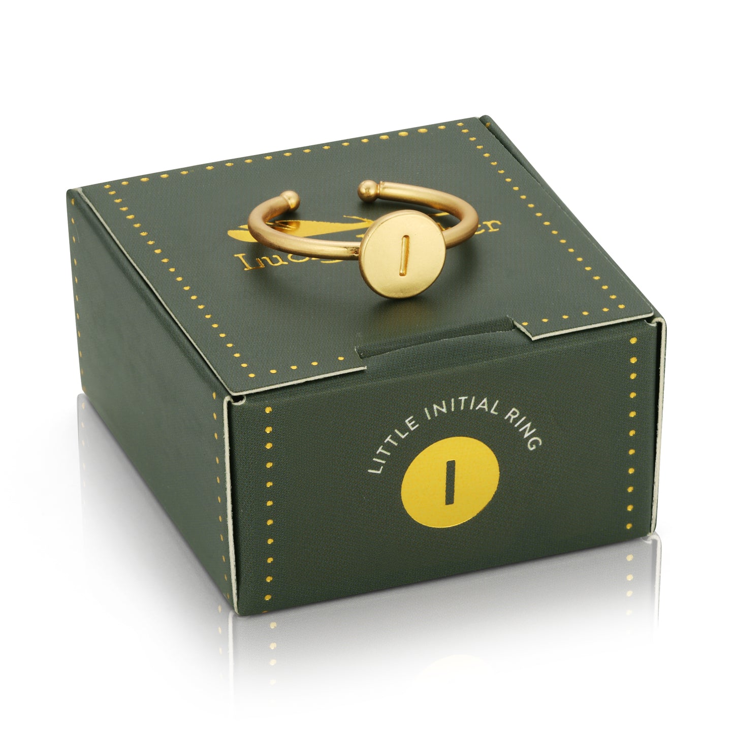 A gold-colored "I" initial ring sits on top of a square, dark green box labeled "LITTLE INITIAL RING" with a gold "I" initial.