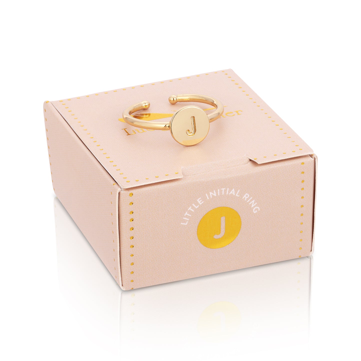A gold ring with the letter "J" on a pink box.
