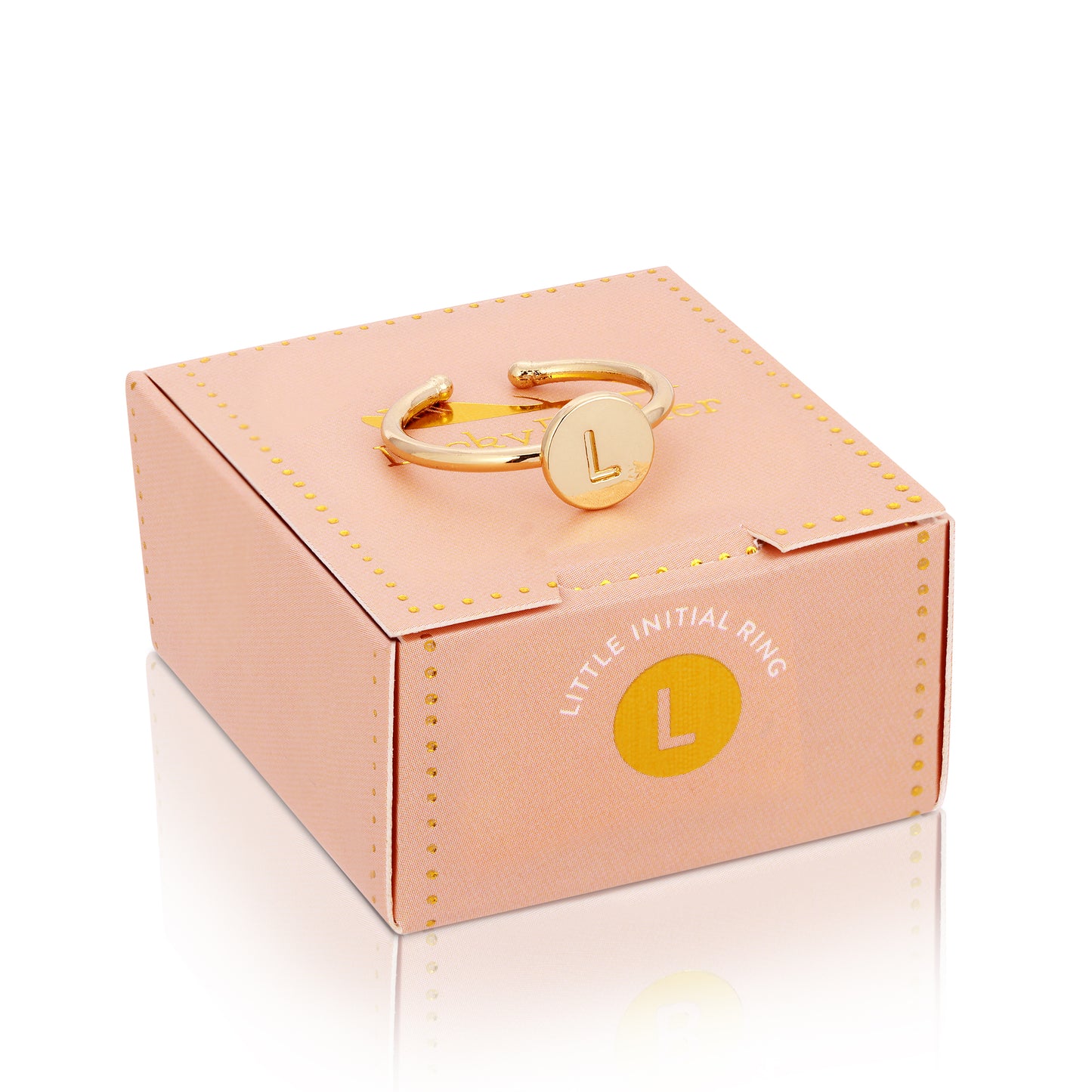 A gold-colored "L" initial ring rests on top of its peach-colored box.