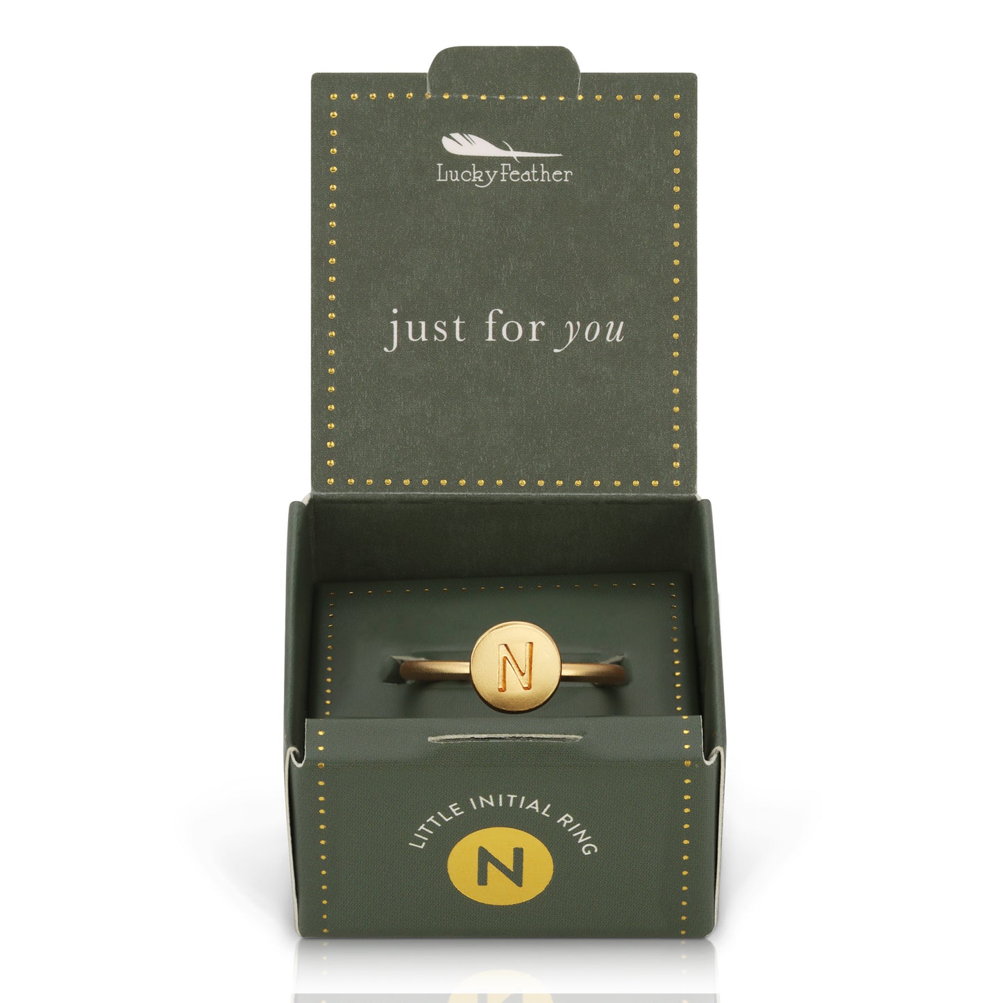 A gold ring with the letter "N" in an open "Lucky Feather" gift box.