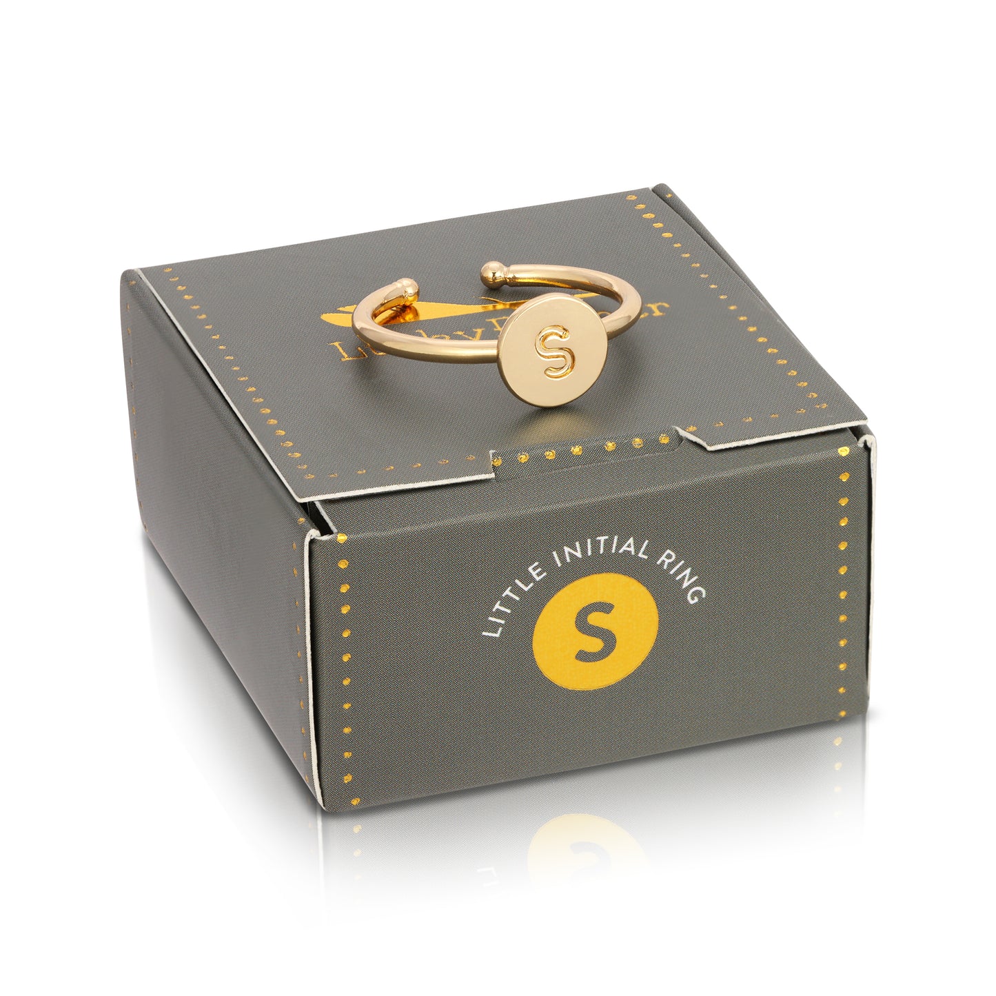 A gold-colored ring with the letter "S" on it is on top of a grey box that has "Little Initial Ring" printed on it.