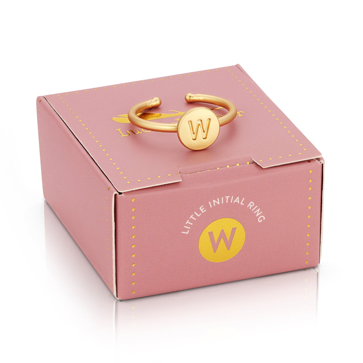 A pink gift box with gold accents displays a gold initial ring with the letter "W".