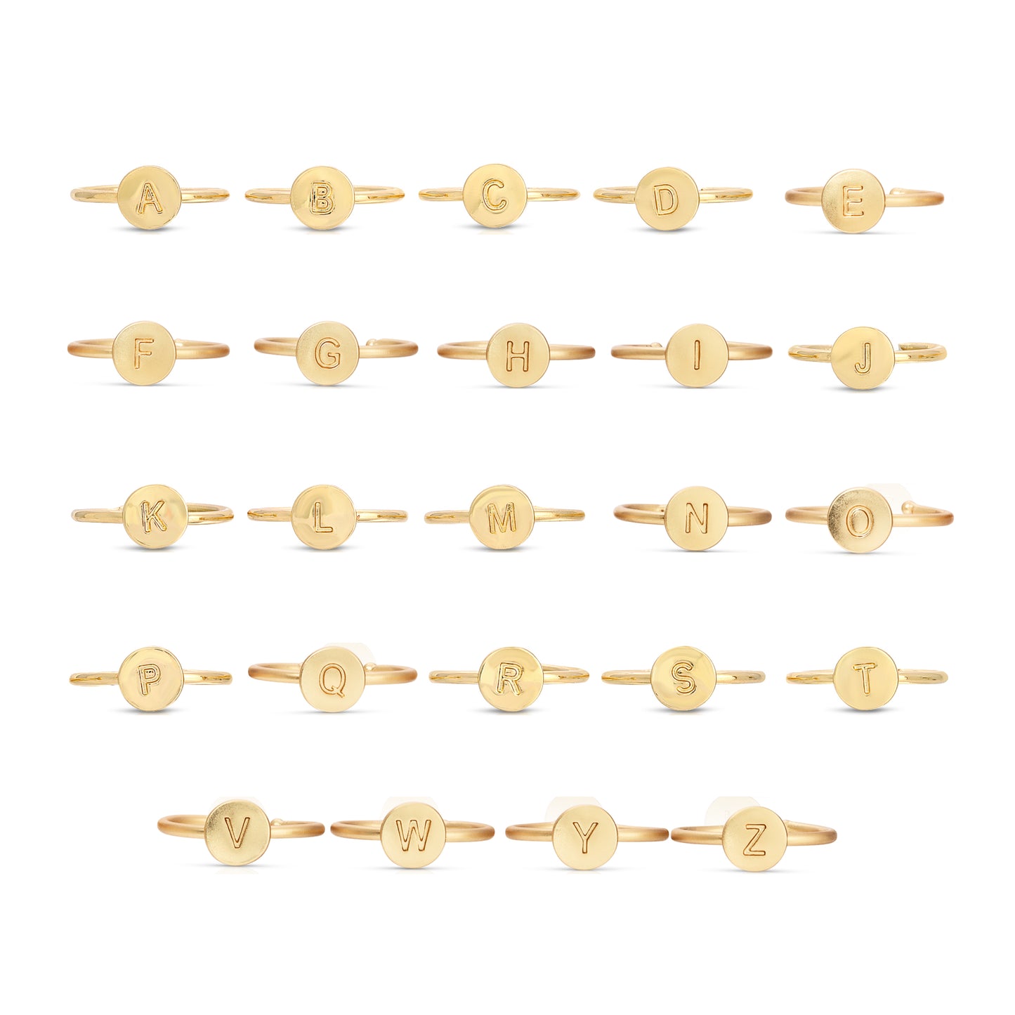 Arrangement of gold rings each featuring a different letter of the alphabet.