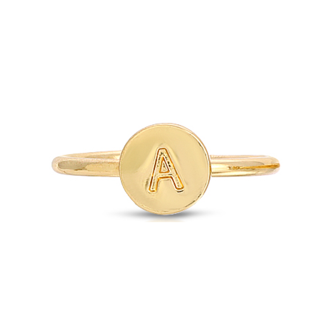 A gold-colored ring features a circular face with the letter "A" on it.