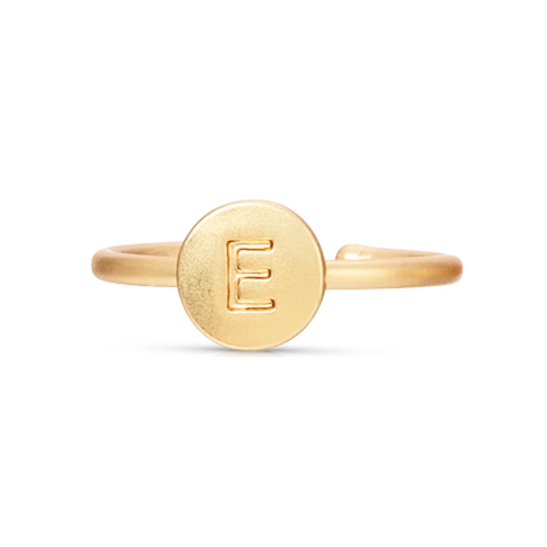 A gold ring with the letter "E" engraved on a circular face.