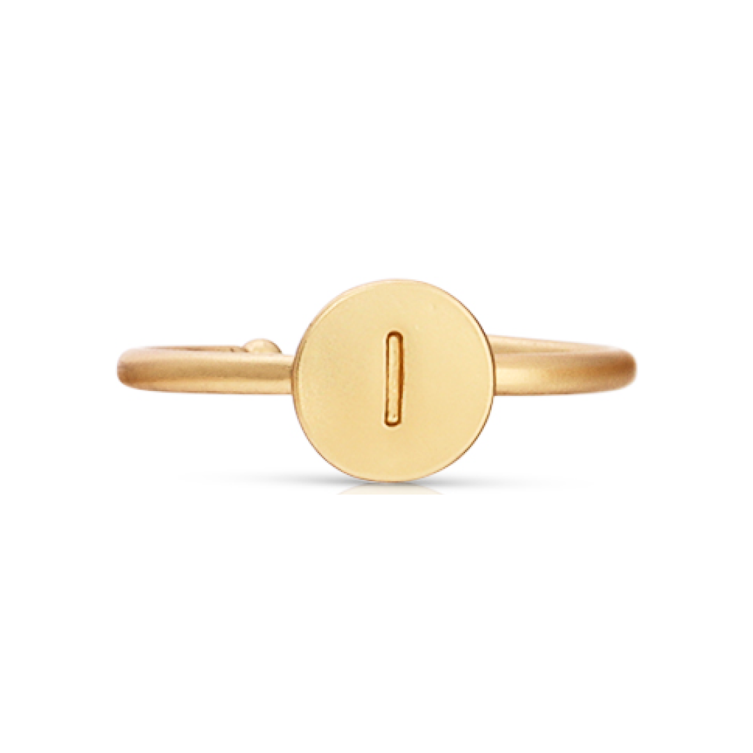 A gold-colored ring features a round face with the letter "I" engraved on it.