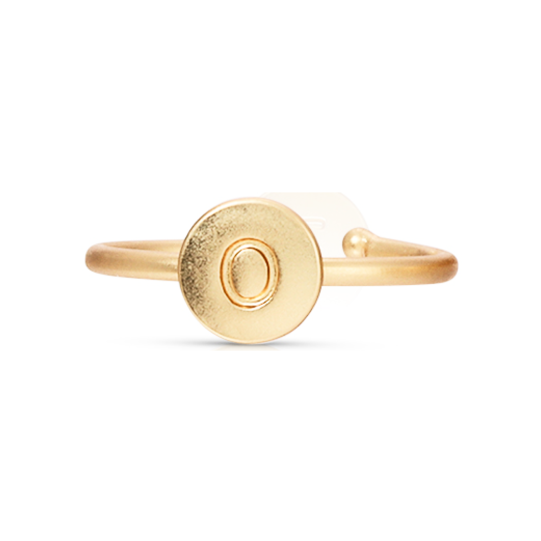 A gold ring features a flat, circular design with the letter "O" engraved on its surface.