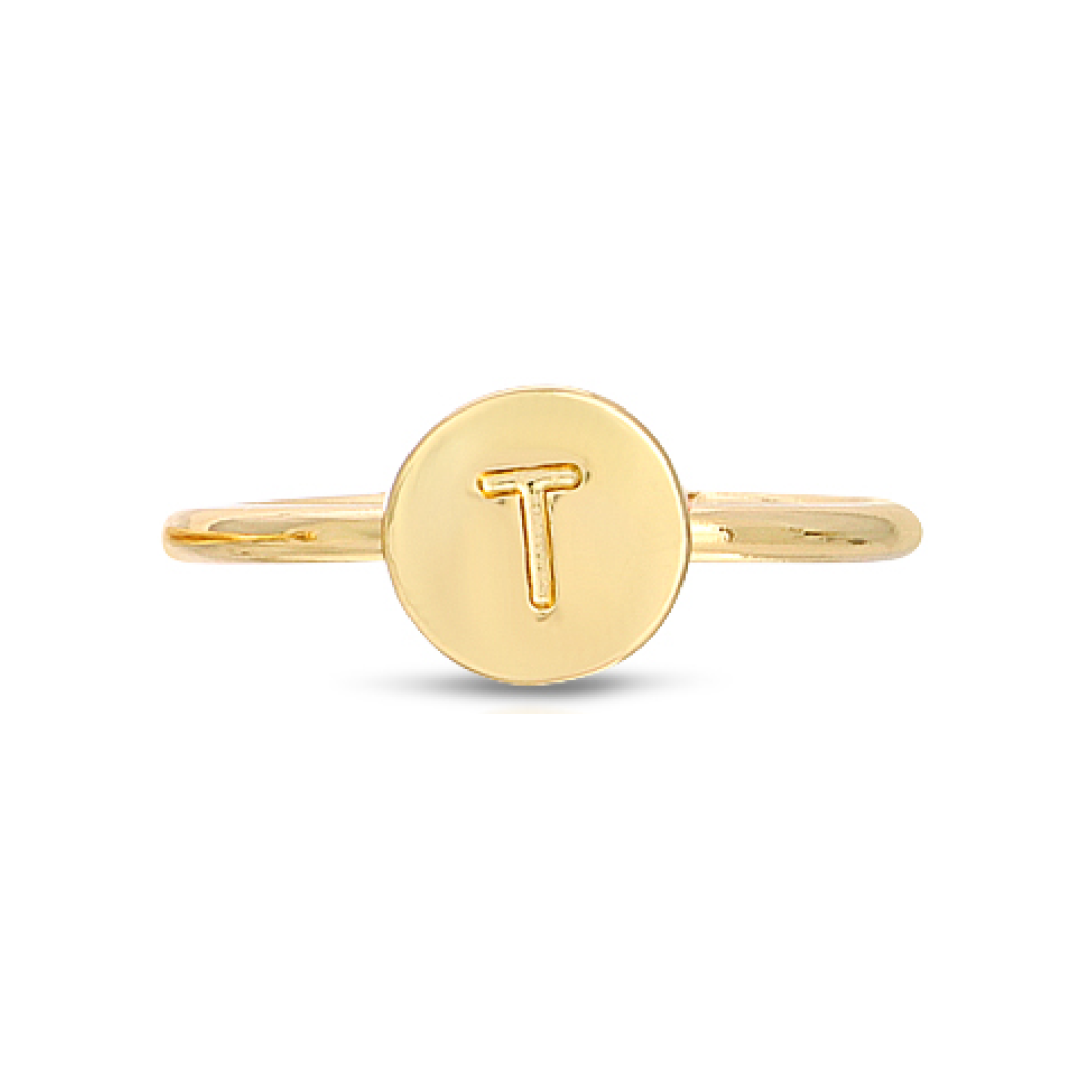 A gold ring features a circular face with the letter "T" engraved on it.