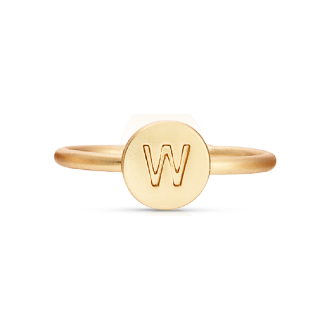 A gold-colored ring features a circular face with the letter "W" inscribed.