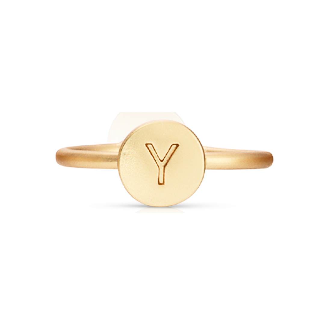 Gold ring with the letter Y engraved on a circular face.