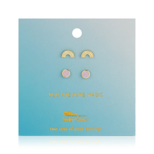 Two sets of post earrings, one with small gold rainbows and the other with pink circles, are displayed on a light blue card.