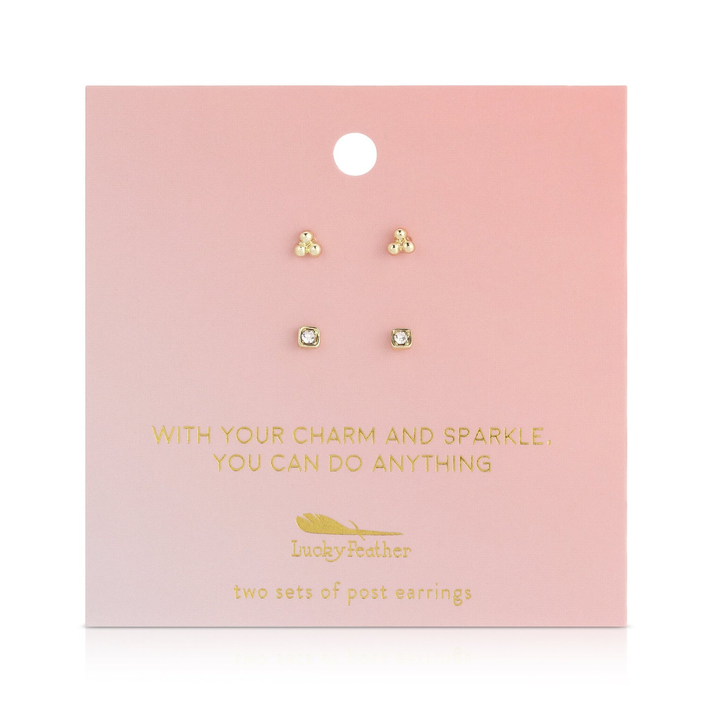 Two sets of stud earrings are displayed on a pink card with gold lettering that says "Lucky Feather" and an inspirational phrase.