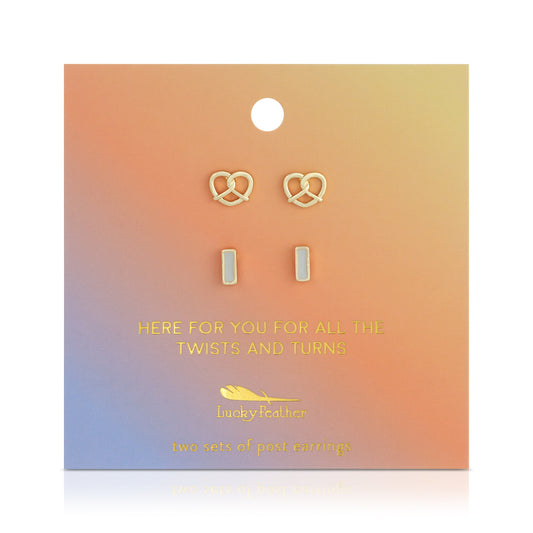 Two sets of post earrings, one pretzel-shaped, are displayed on a gradient-colored card.