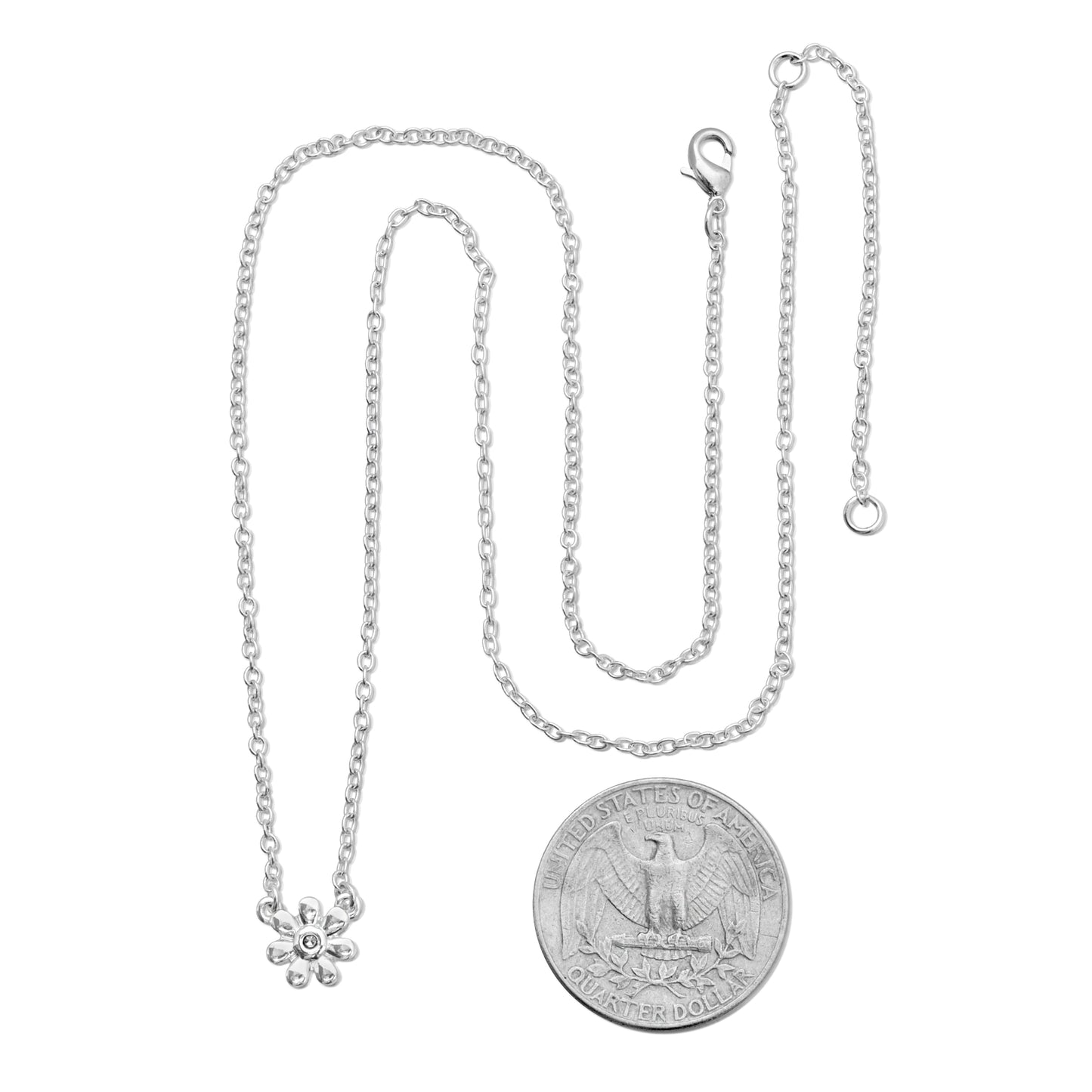 A silver chain necklace with a flower pendant is next to a United States quarter dollar, on a white background.