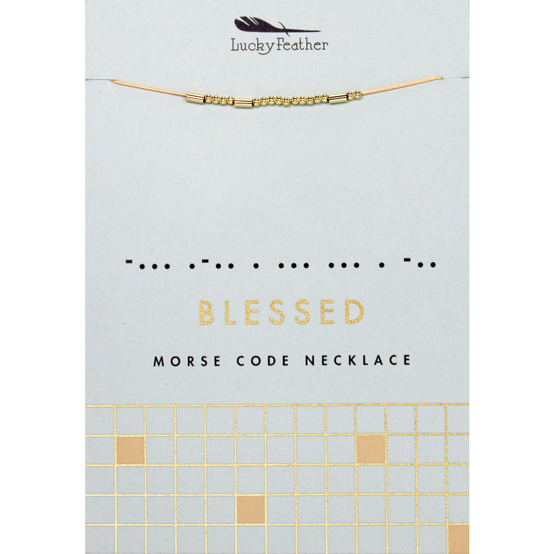 The image displays a "Lucky Feather" necklace with gold beads representing "Blessed" in morse code, on a card with the word "BLESSED" written out and a grid pattern at the bottom.