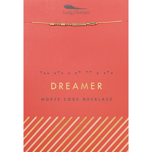 A 'Lucky Feather' brand Morse code necklace that spells out 'Dreamer' on a coral-colored card.