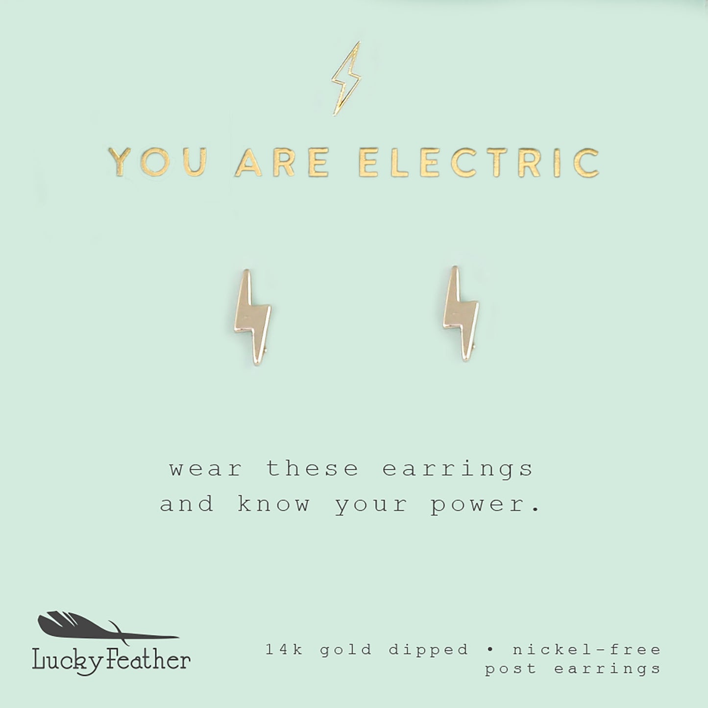 A pair of gold lightning bolt earrings are centered on a light blue card with the text "YOU ARE ELECTRIC" above them.