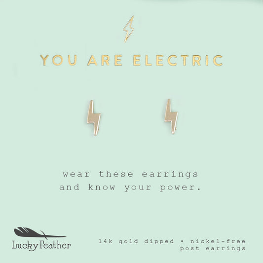 A pair of gold lightning bolt earrings are centered on a light blue card with the text "YOU ARE ELECTRIC" above them.
