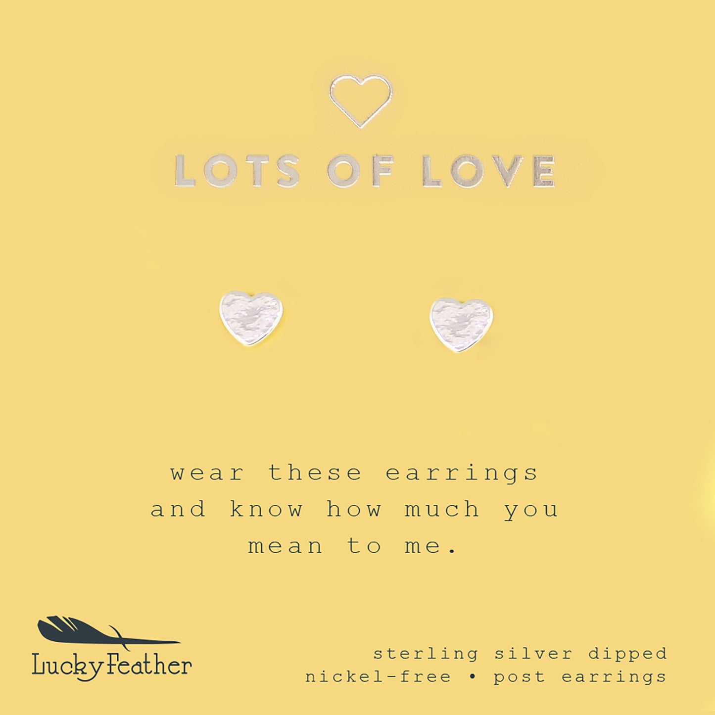 Two silver heart-shaped post earrings on a yellow card with the text "LOTS OF LOVE" and "Lucky Feather."