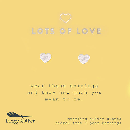 Two silver heart-shaped post earrings on a yellow card with the text "LOTS OF LOVE" and "Lucky Feather."