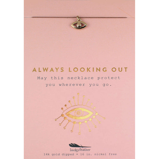 Close-up of a 'Lucky Feather' necklace on a pink card with gold text and graphics.