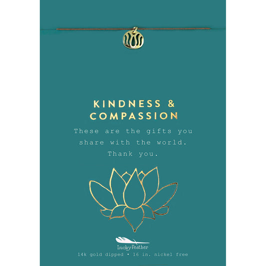 Teal card with a gold charm, lotus flower illustration, and the text "Kindness & Compassion."