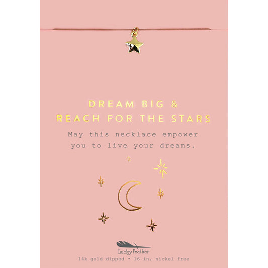 A pink card with a gold star charm hanging above text that reads "DREAM BIG & REACH FOR THE STARS."