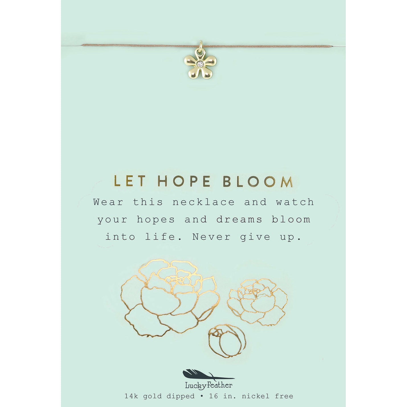 A gold flower pendant hangs from a necklace on a card that reads "LET HOPE BLOOM."