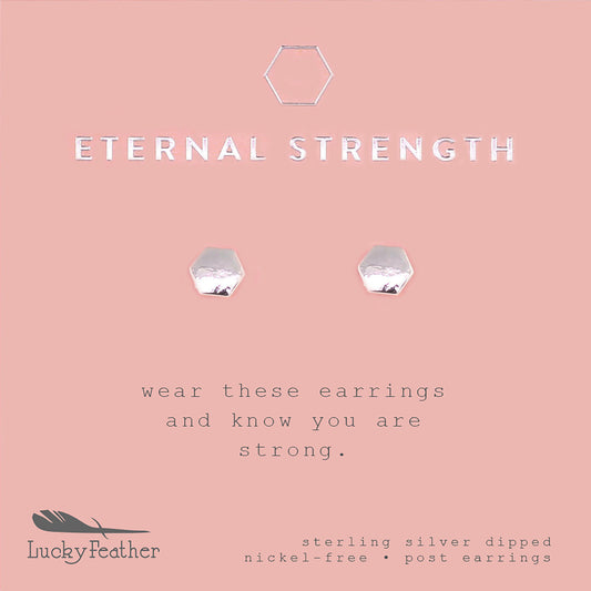 Promotional image for "Lucky Feather" featuring sterling silver dipped, nickel-free, hexagon-shaped post earrings on a pink background with the text "ETERNAL STRENGTH".
