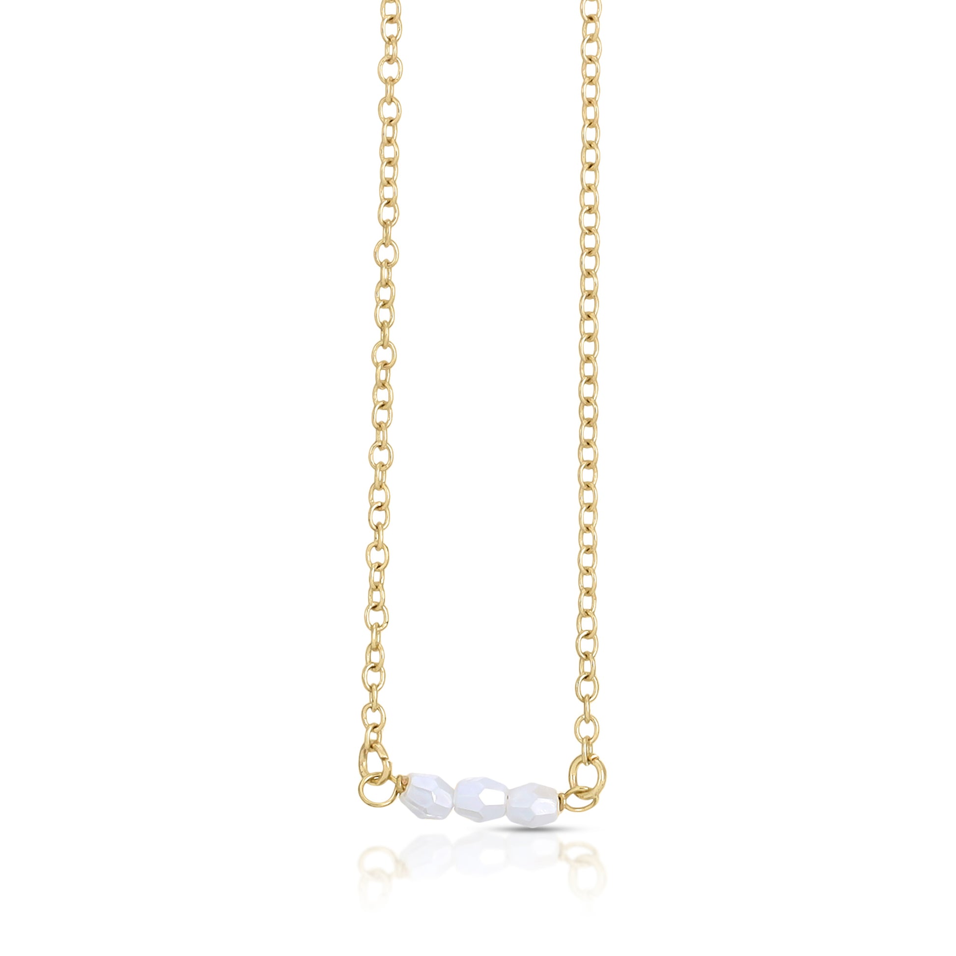 Gold chain necklace with three white faceted beads.