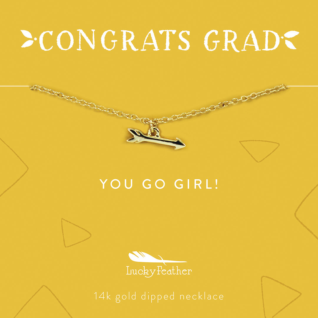 A 14k gold-dipped necklace with an arrow pendant on a yellow card with text "Congrats Grad" and "You Go Girl!" from Lucky Feather.