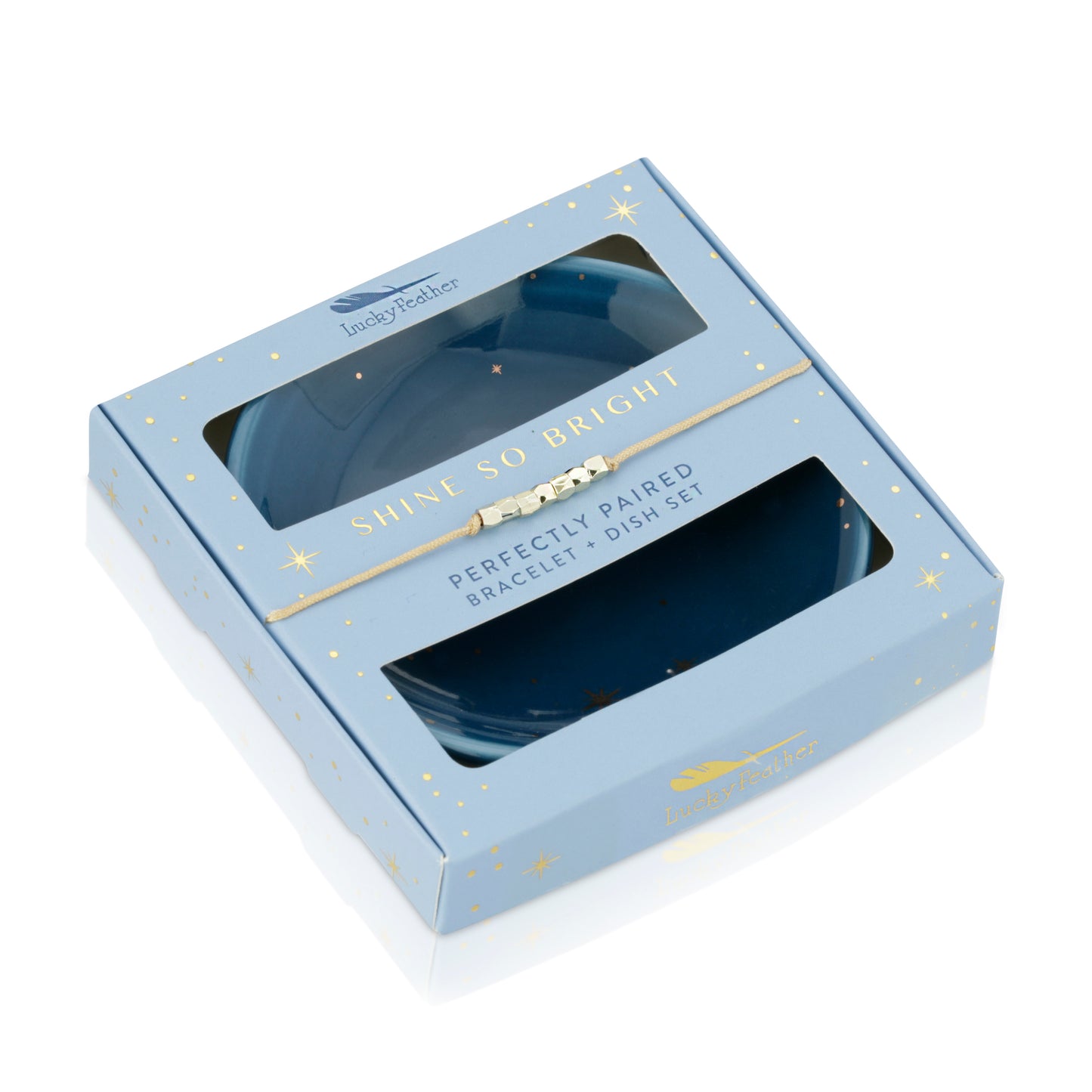 Boxed "Lucky Feather" bracelet and dish set with a light blue star-patterned box and visible contents.
