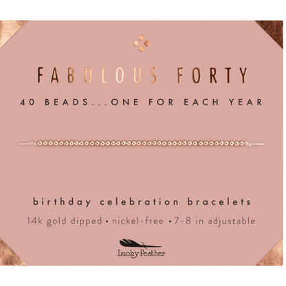 A 'Fabulous Forty' birthday bracelet with 40 beads is displayed on a pink card with gold accents.