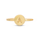 A gold-colored ring features a circular face with the letter
